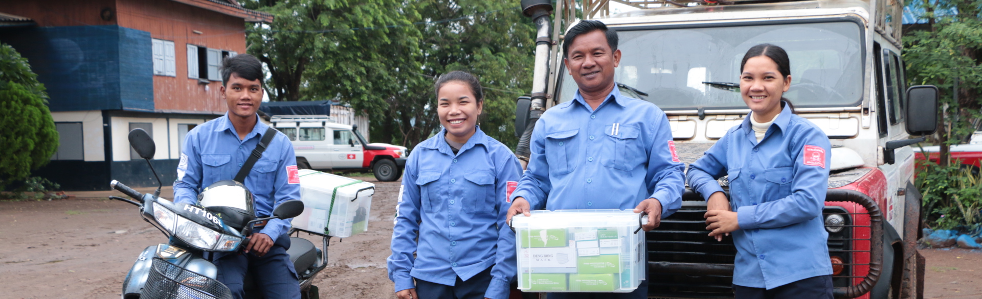 Group of HALO staff in front of a truck carrying emergency supplies