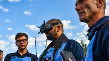 Former Foreign Secretary, James Cleverly, wears a headset whilst operating a drone in a minefield in Ukraine
