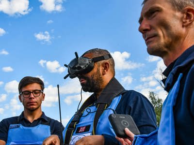 Former Foreign Secretary, James Cleverly, wears a headset whilst operating a drone in a minefield in Ukraine