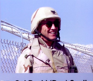 Colonel David Snell in his Air Force kit, wearing sunglasses before a blue sky