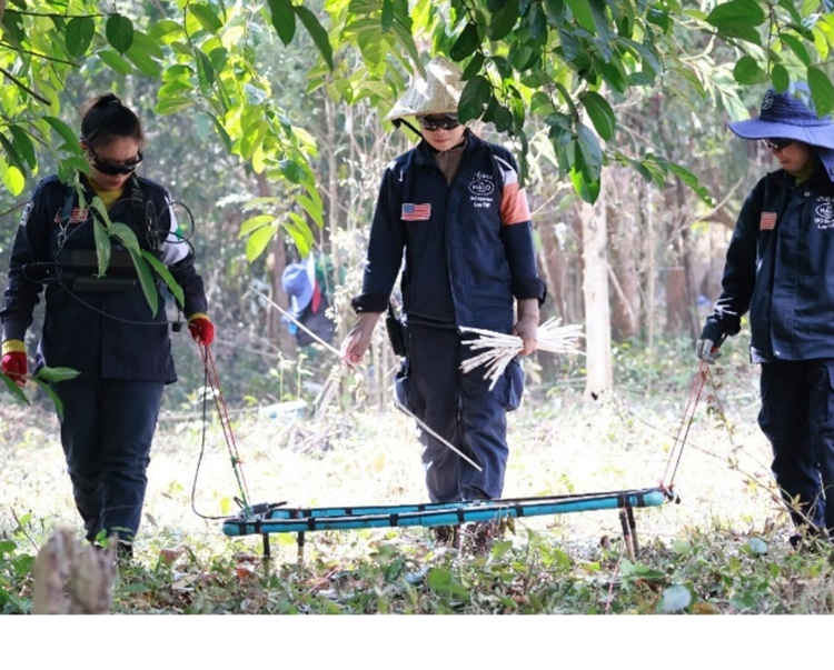 deminers from Laos use a large loop detectors to identify hidden threats