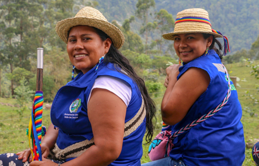Two women from the Kwet Wala indigenous reserve sit outside