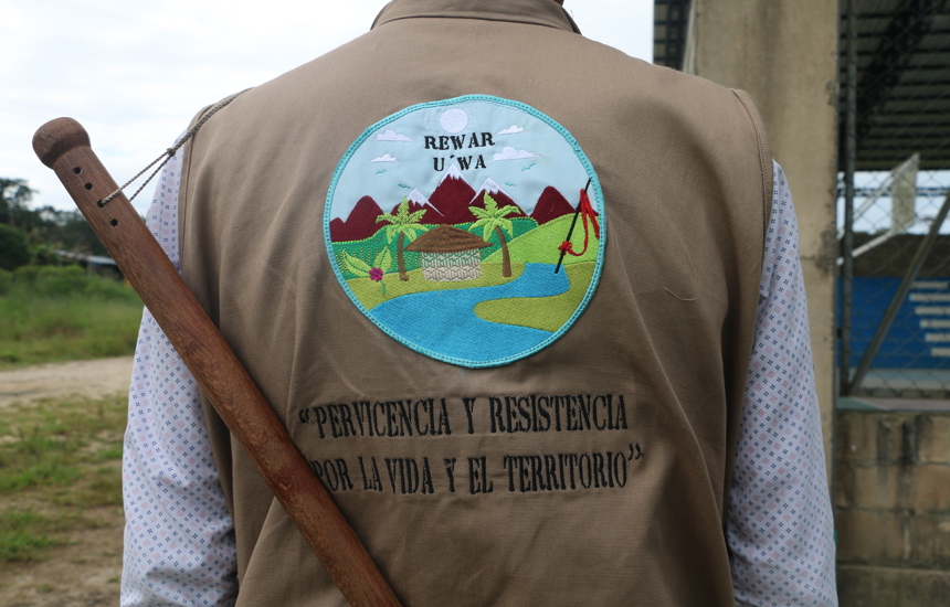 A member of the U'wa Indigenous guard shows a badge depicting their local environment on his back