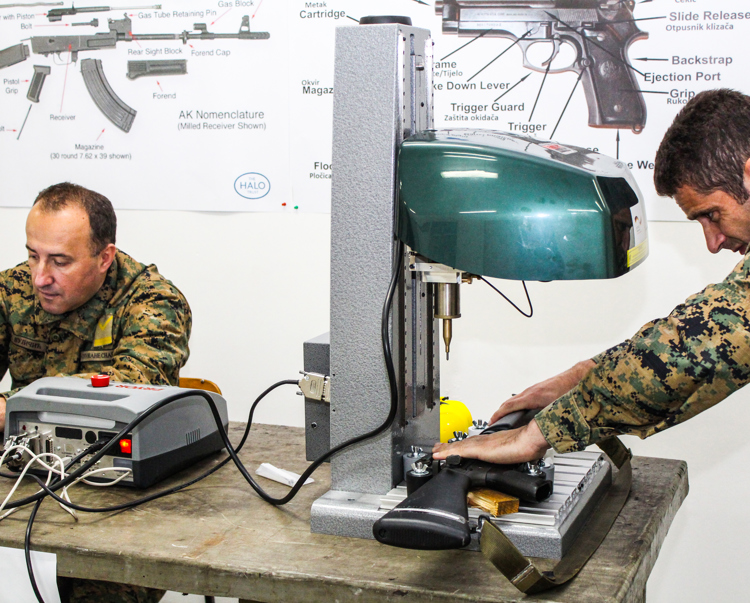 two men mark weapons in Bosnia Herzegovina