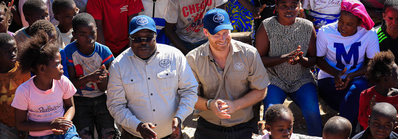 Duke of Sussex with HALO team and local community children.
