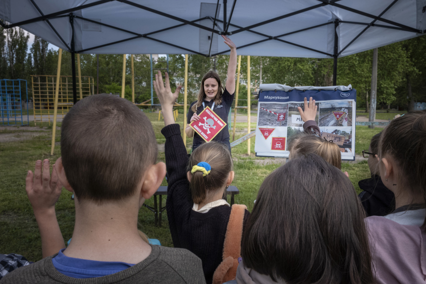 A HALO staff member leads a risk education session outside
