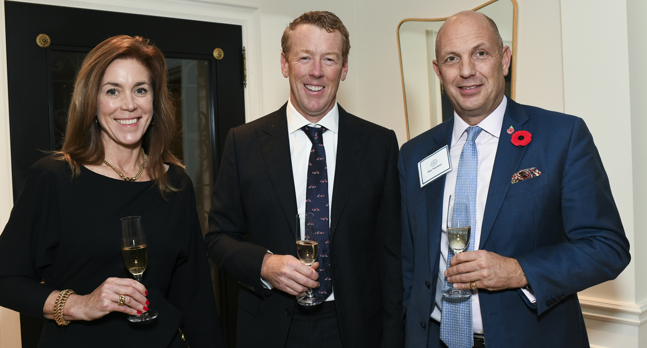 Chief Strategy Officer Rob Thomson smiles with two guests at a formal HALO event