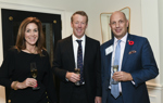 Chief Strategy Officer Rob Thomson smiles with two guests at a formal HALO event