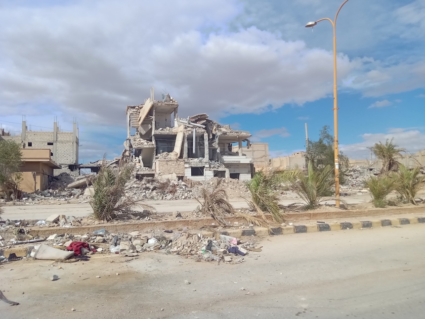 A destroyed building by the road side