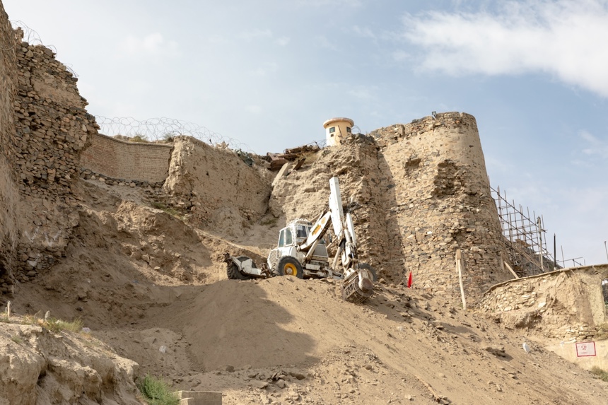 Construction vehicles work around The Bala Hissar, a high fort in Kabul that dates back to the 5th Century