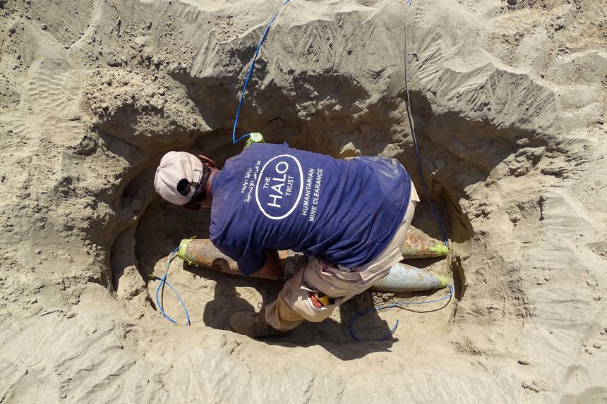 A HALO deminer prepares a hole filled with rockets for demolition in the frontline city of Taiz, Yemen