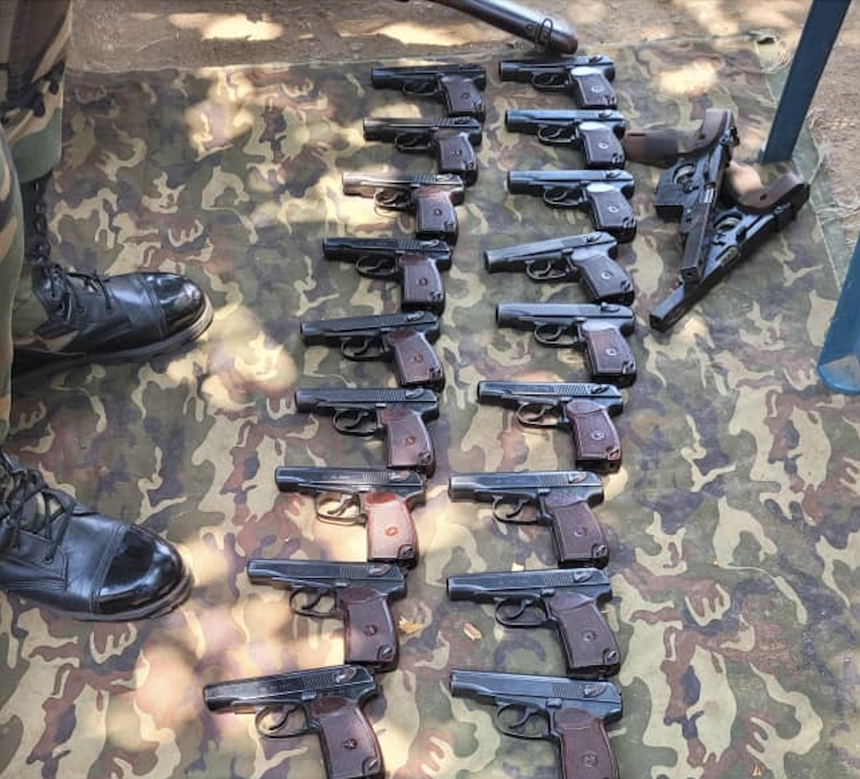 A line of guns lay on the ground