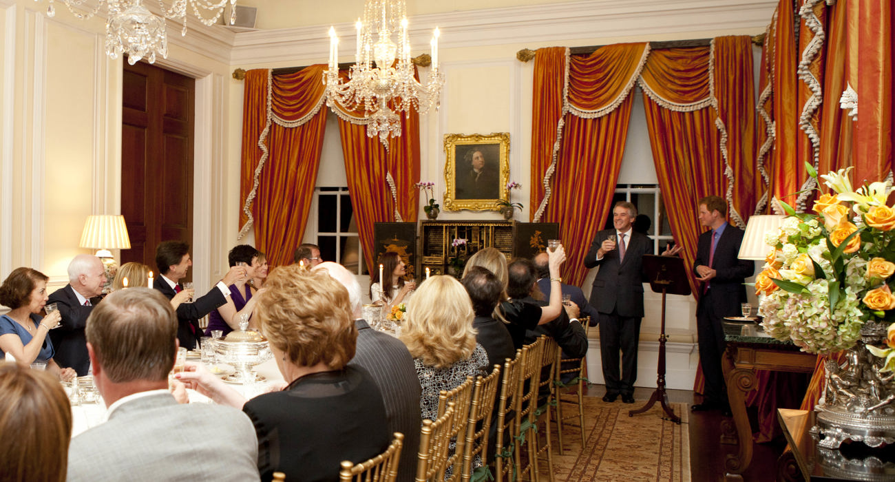 Harry, Duke of Sussex speaks in front of a podium before a room of seated guests