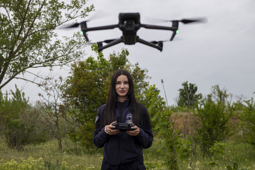 A HALO staff member controls a drone