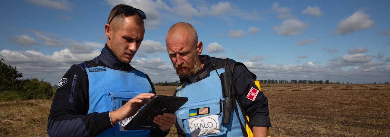HALO staff work with a Trimble device on a minefield