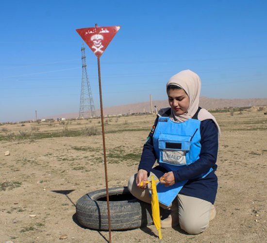 A deminer uses a tyre and stick to mark where an explosive was found
