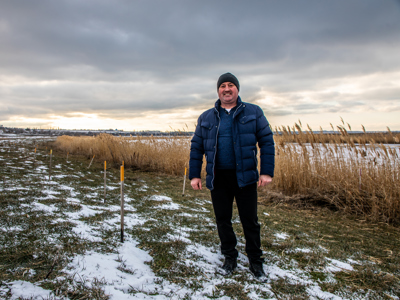 Head of Vasylivka village, Ivan Gentosh, stands next to the Inhulets river where hundreds of explosives were cleared.