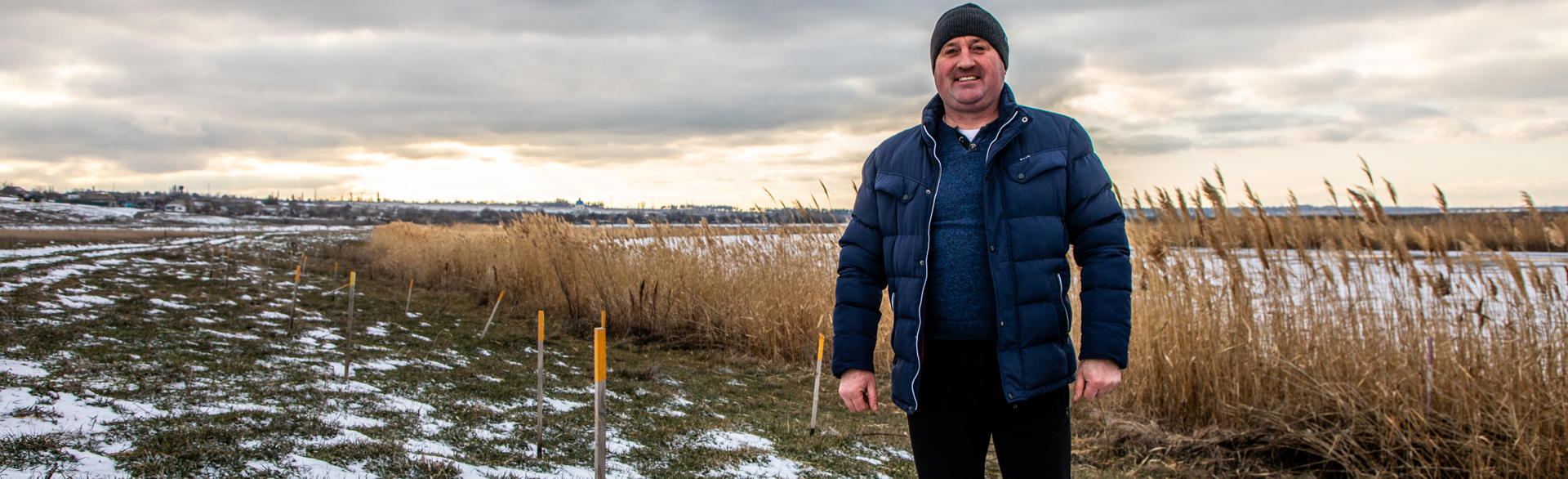 Head of Vasylivka village, Ivan Gentosh, stands next to the Inhulets river where hundreds of explosives were cleared.
